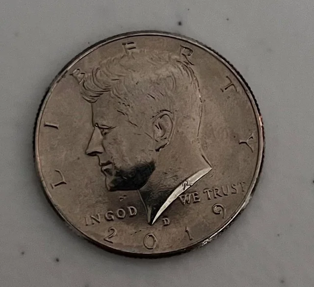 2019 Kennedy half dollar struck-through error showing missing design detail from foreign material during striking