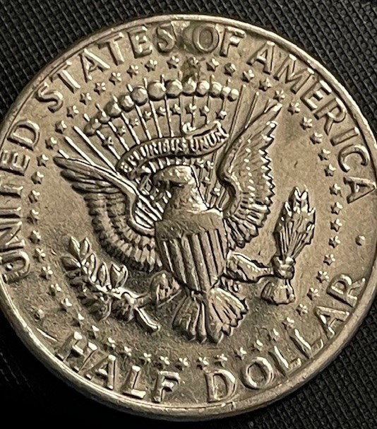 2019 Kennedy half dollar die chip error showing raised metal bumps near date and lettering from die deterioration