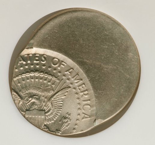 2019 Kennedy half dollar off-center strike error showing design shifted to one side with blank planchet area visible